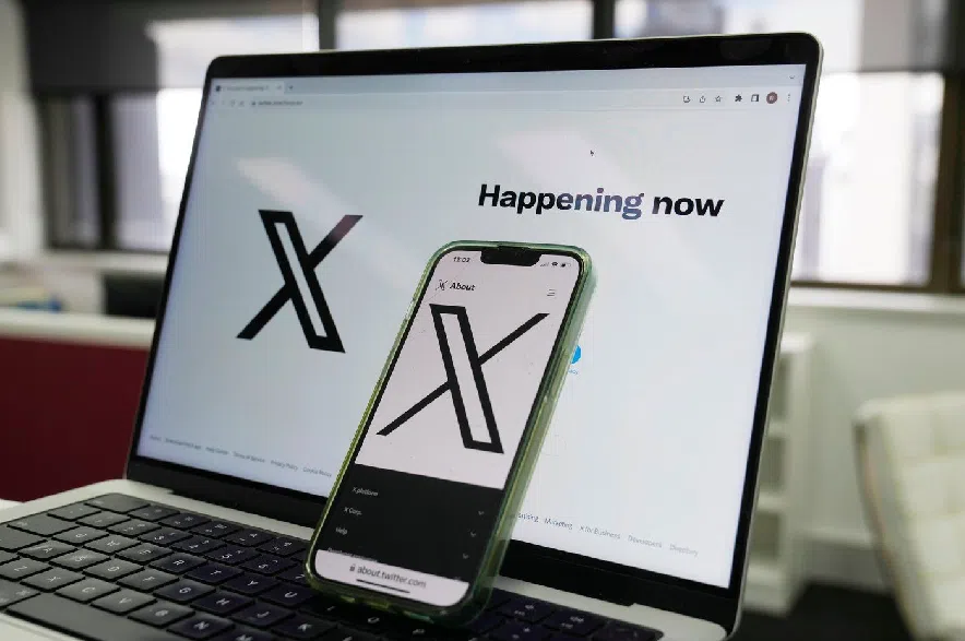 The opening page of X is displayed on a computer and phone, Oct. 16, 2023, in Sydney.