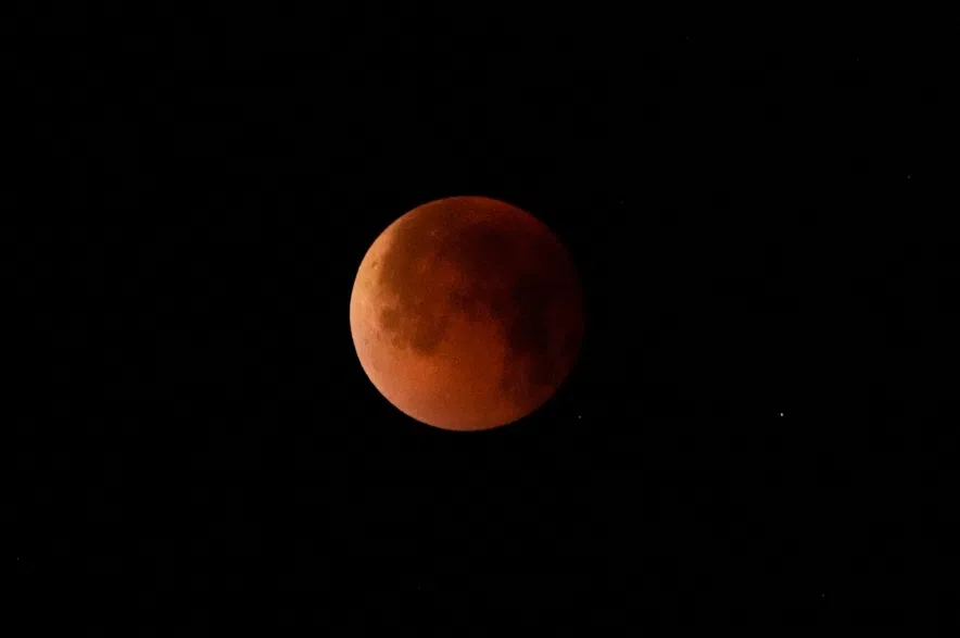 The moon turned red during a total lunar eclipse around 12.07 IST in Kolkata, India, Monday, Sept. 8, 2025.