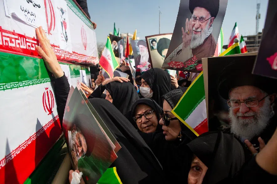 Some holding pictures of the late Iranian Supreme Leader Ayatollah Ali Khamenei, mourners reach out to coffins during a funeral for people killed during the ongoing U.S.–Israeli military campaign in Isfahan, Iran, Thursday, March 5, 2026.