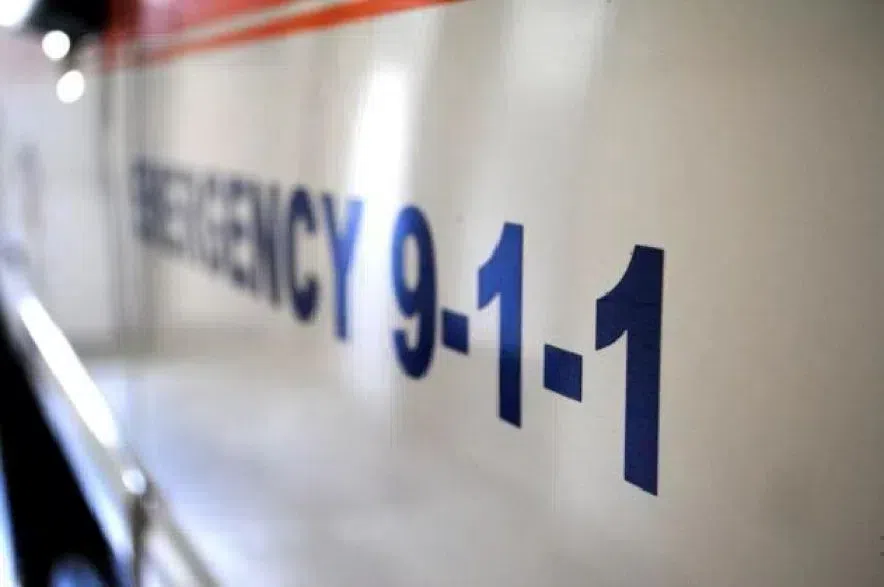 An ambulance with emergency 911 written across the side.