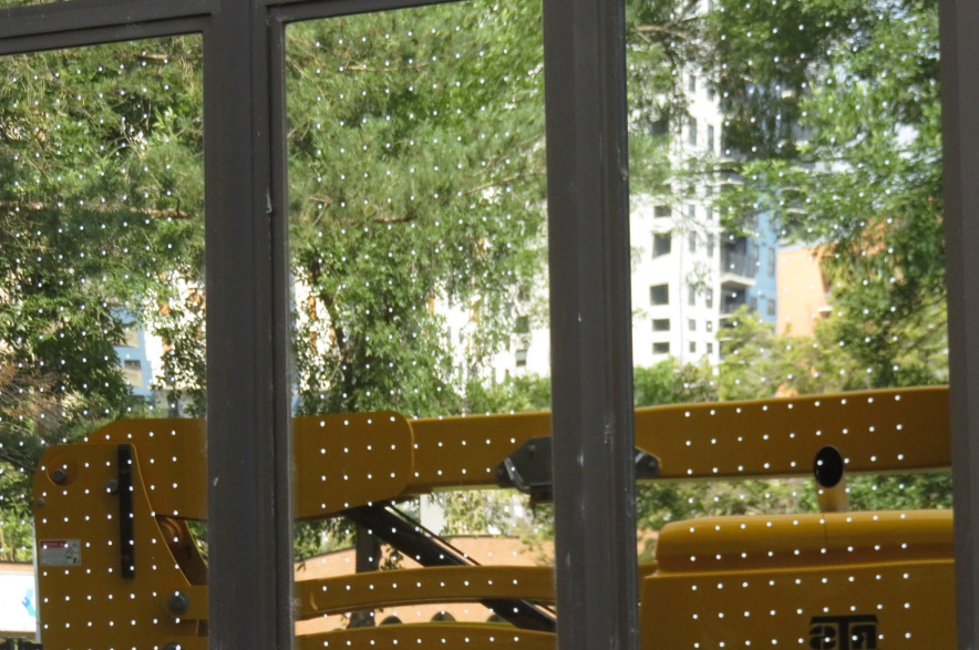 Windows with white dots on north side of Saskatoon City Hall.