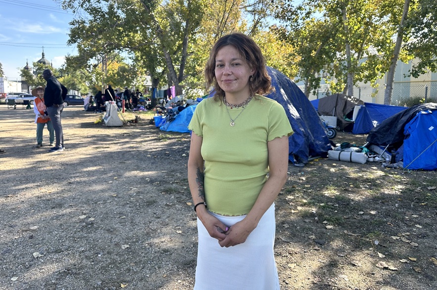 Amena Stene stands in the encampment on 20th Street at Avenue K on Sept, 24, 2026. She said she hopes everyone can understand that every person has their own struggles, whether or not they live in a tent city. (Libby Gray/650 CKOM)