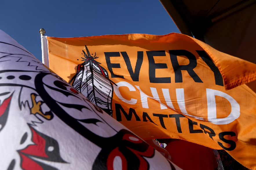 An Every Child Matters flag flies in the breeze during the second annual South Island Powwow at Royal Athletic Park in Victoria on Saturday, Sept. 30, 2023.