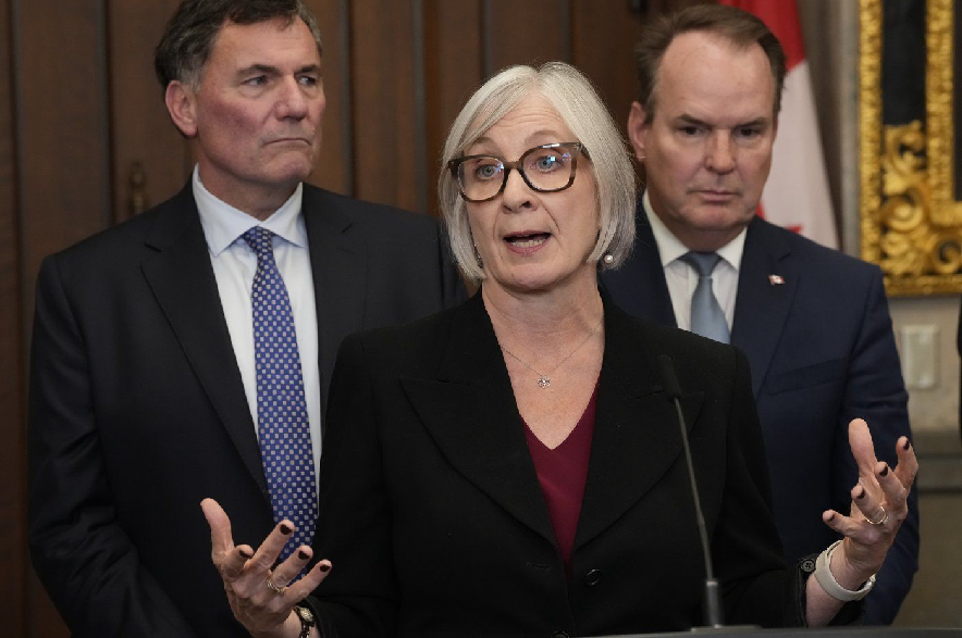 Transport Minister Steven MacKinnon, right, and Minister for Canada-U.S. Trade Dominic LeBlanc listen as Jobs Minister Patty Hajdu speaks during a news conference in the Foyer of the House of Commons in Ottawa on Monday, Sept. 21, 2026.
