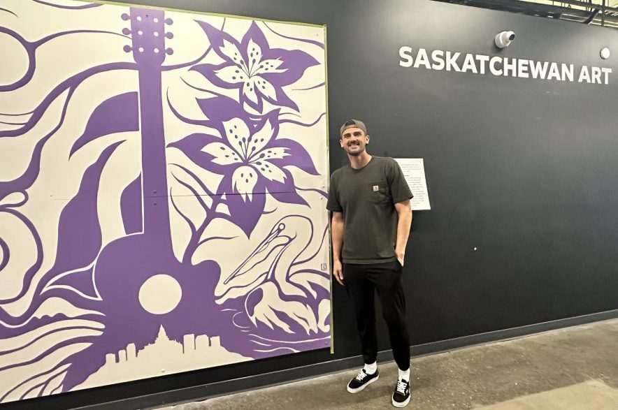 Saskatchewan artist, Chris Chipak, stands alongside his completed mural inside Gather Local Market in Saskatoon on Sept. 15, 2026. (Libby Gray/650 CKOM)