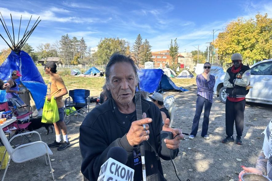 David Fineday, considered the "mayor" of the encampment, speaks with reporters on Sept. 25, 2026 at the site, after experiencing a bathroom incident. (Libby Gray/650 CKOM)