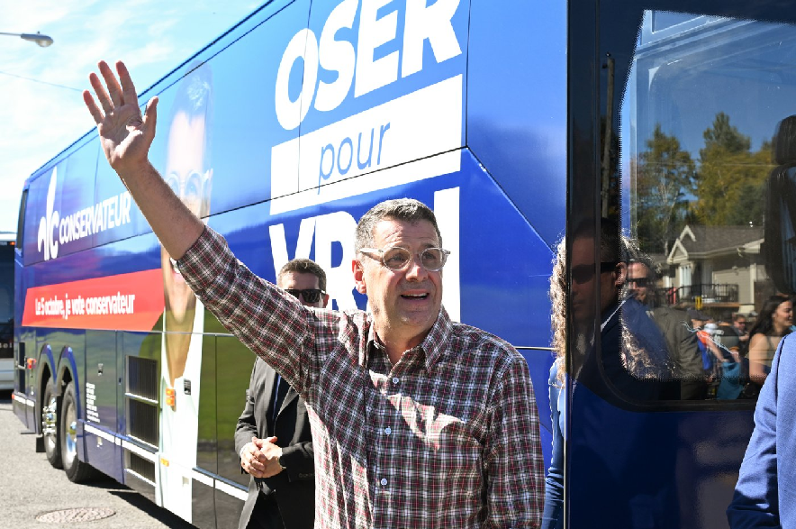 Quebec Conservative Leader Eric Duhaime waves to the crowd at a softball tournament while campaigning in Sainte-Brigitte-de-Laval, Que., Saturday, Sept. 26, 2026. Quebecers are going to the polls for a provincial election on Oct. 5.
