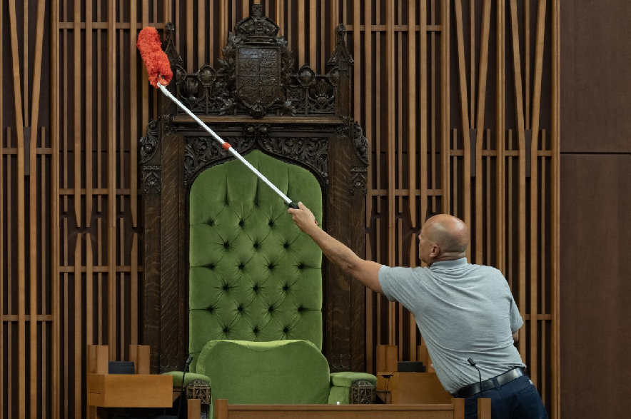 A House of Commons maintenance and material handling employee wipes down the Speakers chair in the House of Commons during a photo op in Ottawa, Thursday, Sept. 17, 2026.