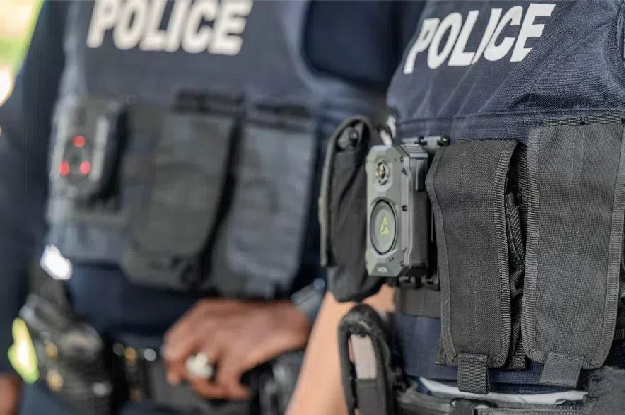 Two Saskatchewan RCMP officers wearing vests and body cameras.