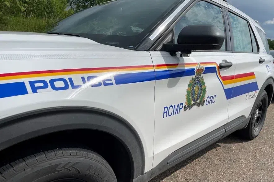 A Saskatchewan RCMP SUV, parked on a gravel road.