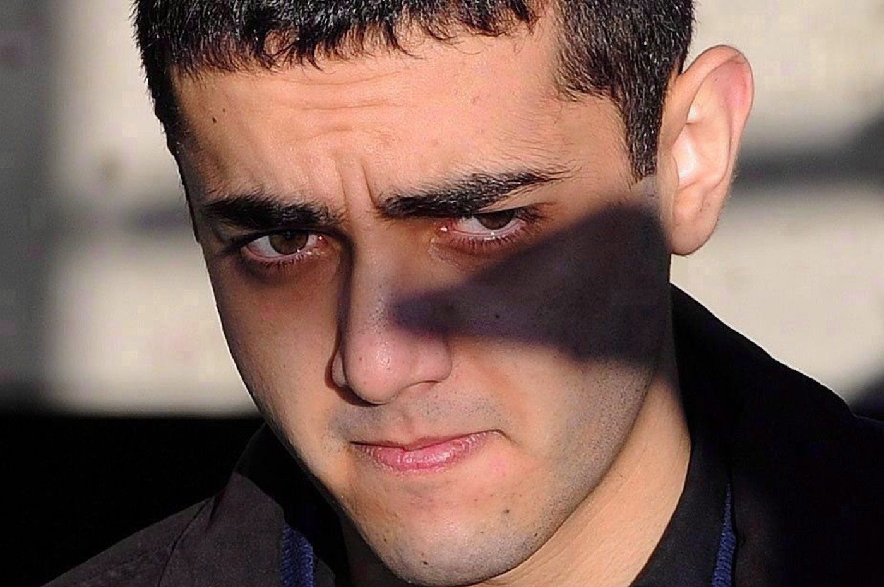 Hamed Mohammed Shafia is escorted by police officers into the Frontenac County courthouse in Kingston, Ont., on Jan. 18, 2012.
