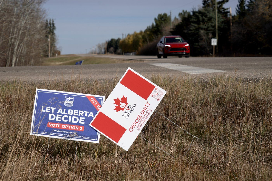 Political signs are posted on a rural road in Wainwright, Alta., on Monday, Oct. 19, 2026.