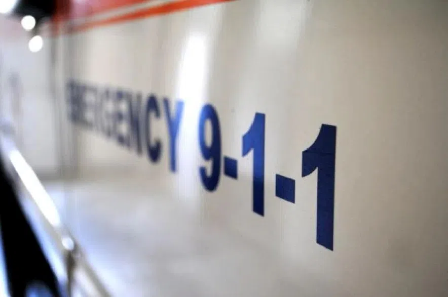 An ambulance with emergency 911 written across the side.