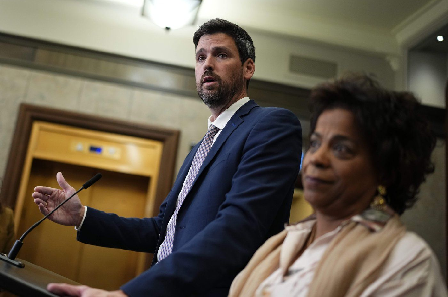 Minister of Justice Sean Fraser speaks as Minister of Health Marjorie Michel looks on during a media availability on Parliament Hill in Ottawa, on Wednesday, Oct. 7, 2026.