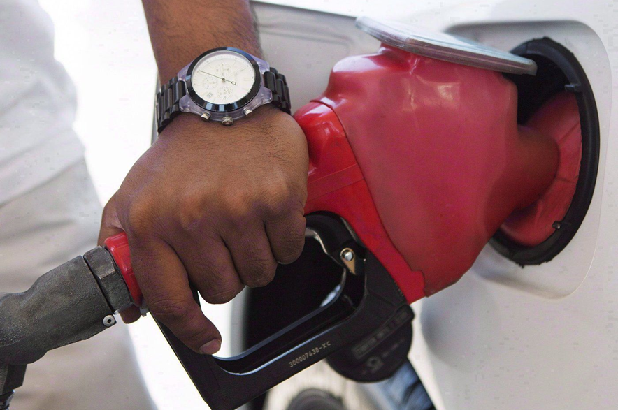 A person pumps fuel in Toronto after gasoline prices rose overnight on Wednesday, September 12, 2012.