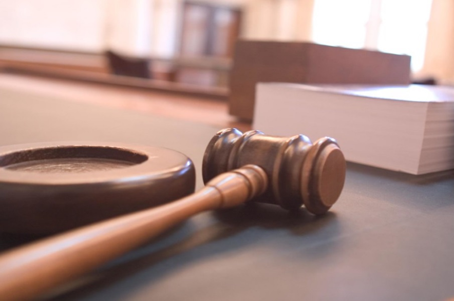 A judge's gavel sitting on a desk.