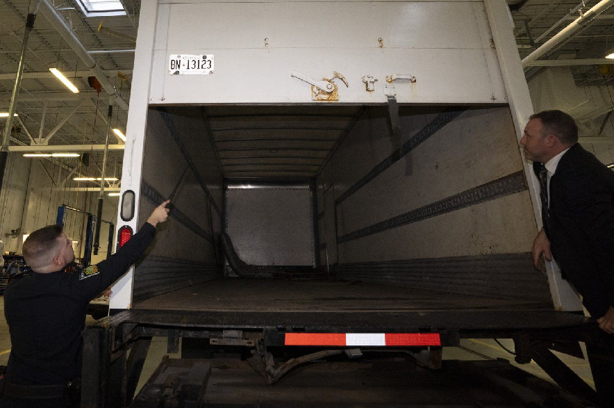 Police officers open the back of a recovered truck during a press conference regarding Project 24K a joint investigation into the theft of gold from Pearson International Airport, in Brampton, Ont., on Wednesday, April 17, 2024.