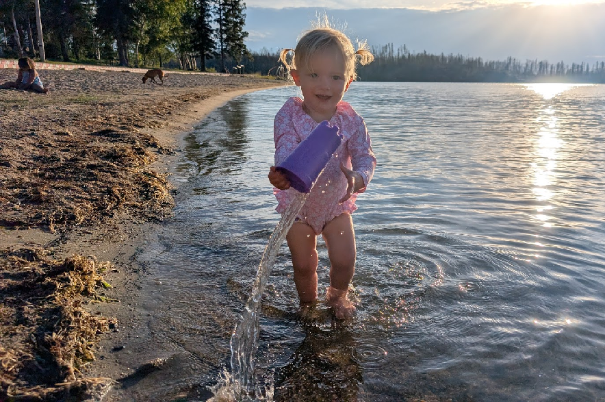 14-month-old Callie Kindel playing on a beach.