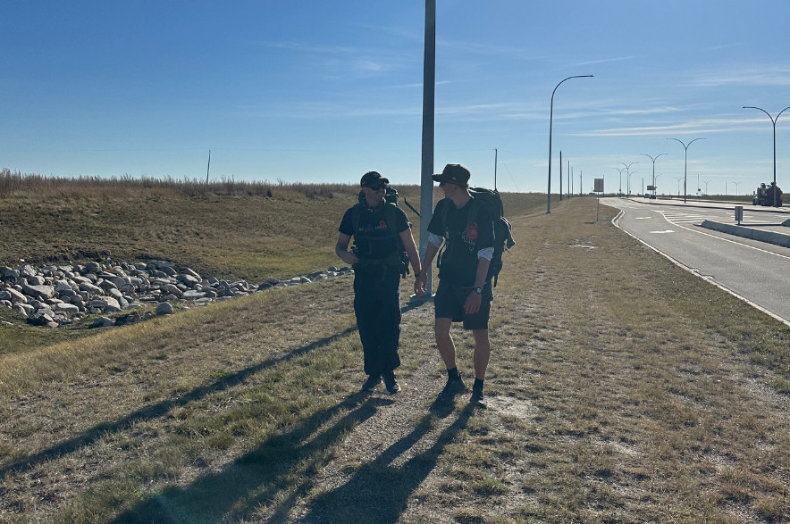 Owen Schultz and Ethan Spiess walk along Central Avenue in Saskatoon.