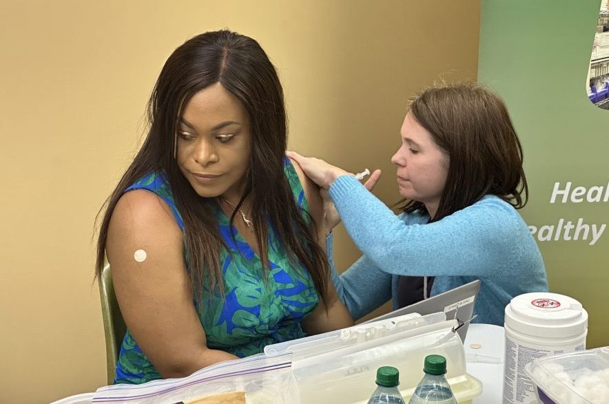 SHA public health nurse, Camille Wionzek, gives Dr. Vivian Onaemo her COVID-19 and influenza vaccines on Oct. 13, 2026. (Libby Gray/650 CKOM)