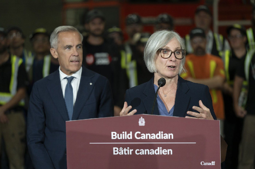 MP Patty Hajdu speaks ahead of Prime Minister Mark Carney, left, during a visit to the Alstom Plant in Thunder Bay, Ontario, on Thursday, Sept. 3, 2026.