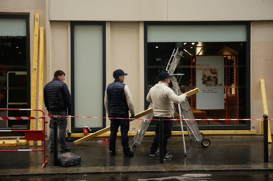 Workers board up a storefront on the eve of a demonstration against rising living costs in Paris, Friday, Oct. 23, 2026.