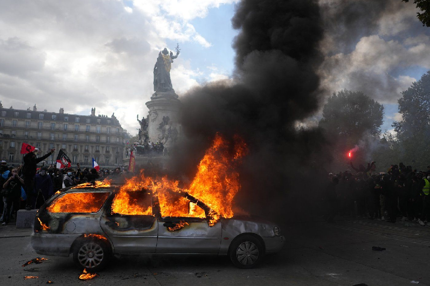 A car burns at Republique square during a protest against rising living costs, joining students' grievances, in Paris, Saturday, Oct. 17, 2026.