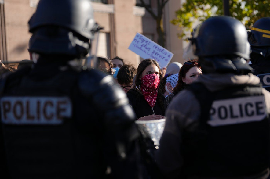 Students face police officers in front of the Helene Boucher high School during a protest against under-resourced schools, in Paris, Thursday Oct. 8, 2026.