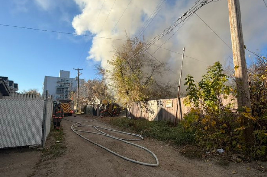 Saskatoon fire crews douse flames coming from a detached garage on Oct. 22, 2026.