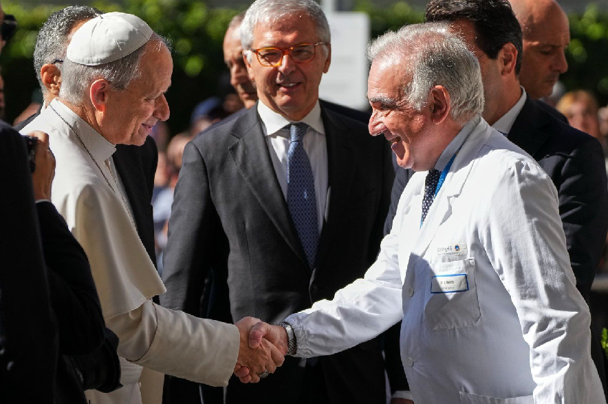 Medical Director Andrea Cambieri, right, greets Pope Leo XIV as he arrives at the Agostino Gemelli Polyclinic in Rome on Tuesday, Oct. 13, 2026, where doctors expect to operate to remove a lung nodule.