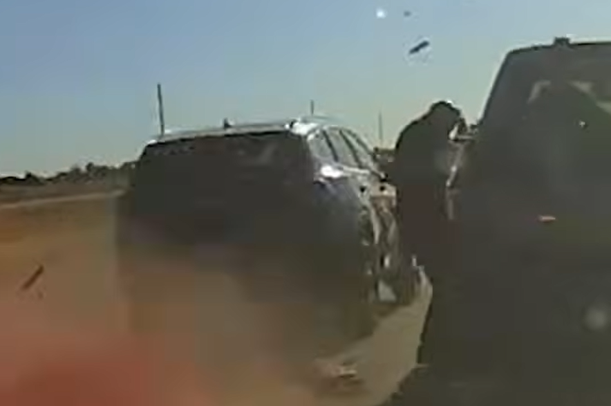 A screenshot from a video released by the Saskatchewan RCMP, showing an officer nearly getting hit by a passing SUV near Lashburn on Thursday, Oct. 8, 2026.