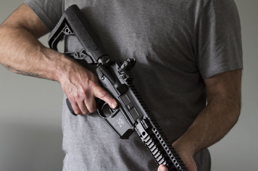 A restricted gun licence holder holds a AR-15 at his home in Langley, B.C., on Friday, May 1, 2020.