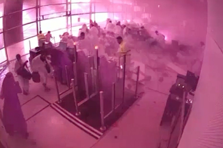 This image from CCTV video released by Saudi Arabia's Media Ministry shows passengers taking cover as flames and smoke fill part of King Khalid International Airport in Riyadh, Saudi Arabia, during what authorities described as a strike at the airport on Saturday, Oct. 10, 2026.