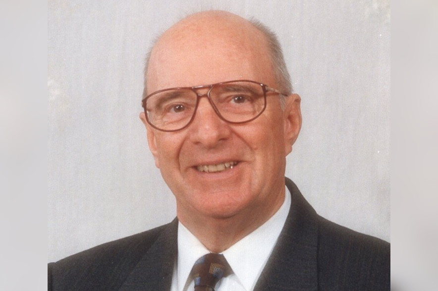 Aloys “Al” Schwinghamer, wearing a suit and tie in an undated portrait photograph.