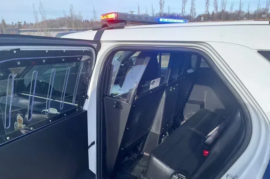 The backseat of a Saskatoon police SUV, with the door open.