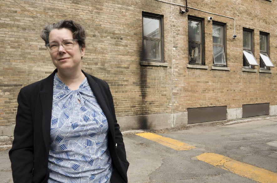 Rabbi Lisa Grushcow is seen near a burnt-out window at Temple Emanu-El-Beth-Shalom synagogue in Westmount, Que., on the Island of Montreal on Friday, June 5, 2026. The temple was targeted overnight in an arson attempt. Grushcow described the location as the room where Jewish life happens.