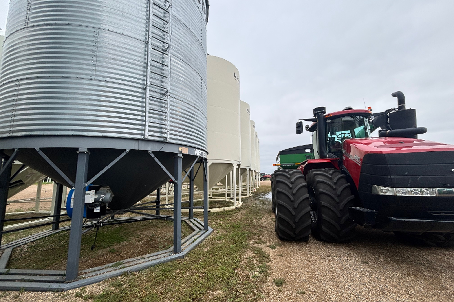 A tractor sitting next to a grain bin on a Saskatchewan farm.