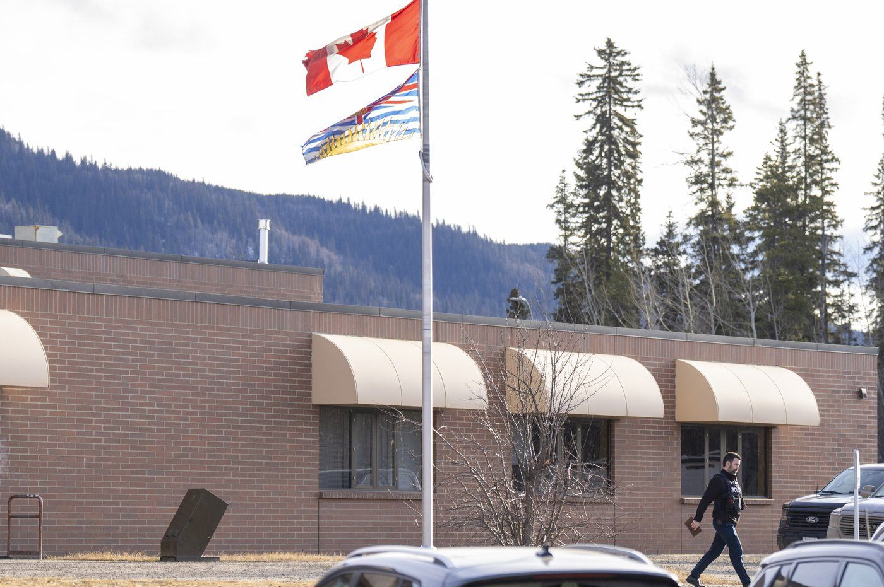 An RCMP officer walks out of the school where a mass shooting took place in Tumbler Ridge, B.C., on Thursday, Feb. 12, 2026.