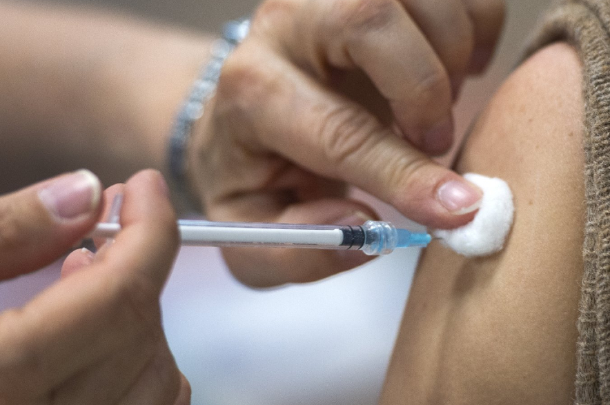 A person gets the COVID-19 vaccine.