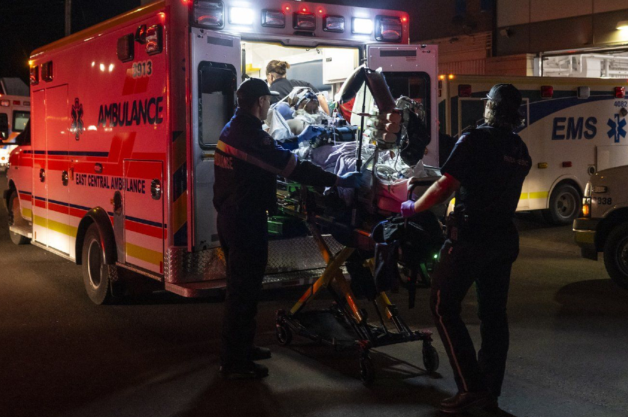 Paramedics load an injured person into an ambulance at the Wainwright Health Centre.