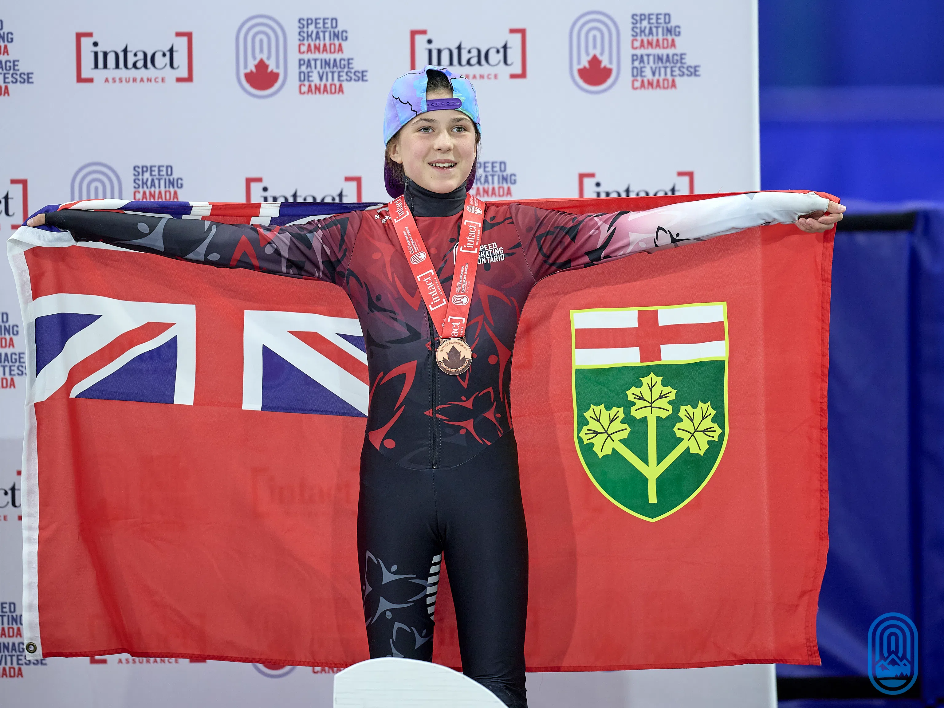 McKendry proudly holding her province's flag on the podium | Photo Credit: Jack MacDonald