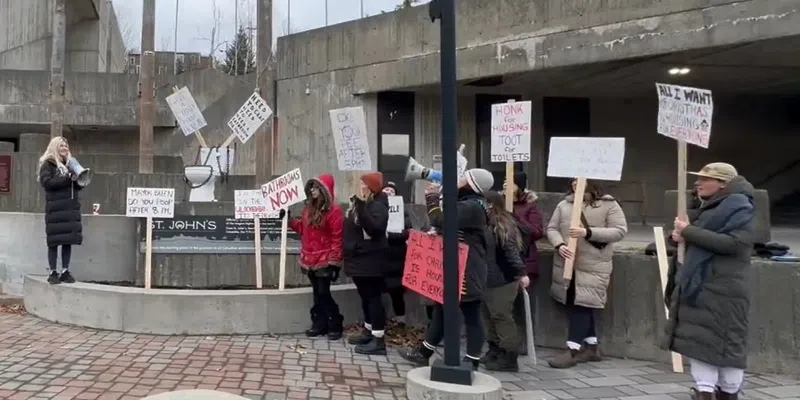 Demonstrators Rally Outside City Hall for Access to Toilets for Tent City