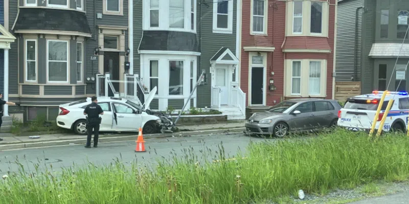 One Person in Custody After Car Strikes Parked Vehicle, Home on Pennywell Road