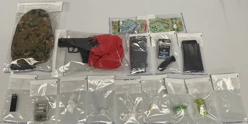 Man Passed Out Behind Wheel Arrested and Charged, Drugs and Weapons Seized